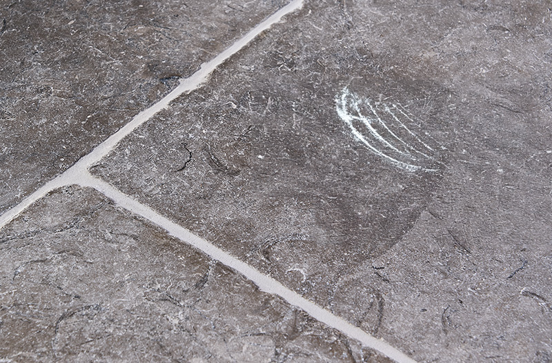 A scratched natural stone tile